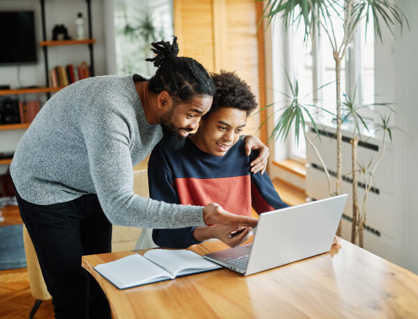 Father helping son with computer